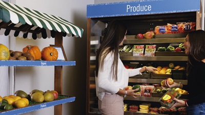 A student explores fresh produce at Fox Lodge which offers locally grown, organic produce rotated for peak ripeness.