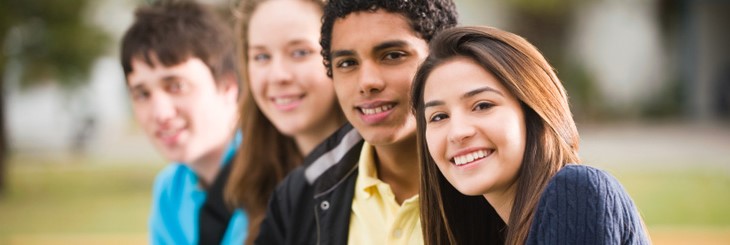 A group of young people arranged in a row.
